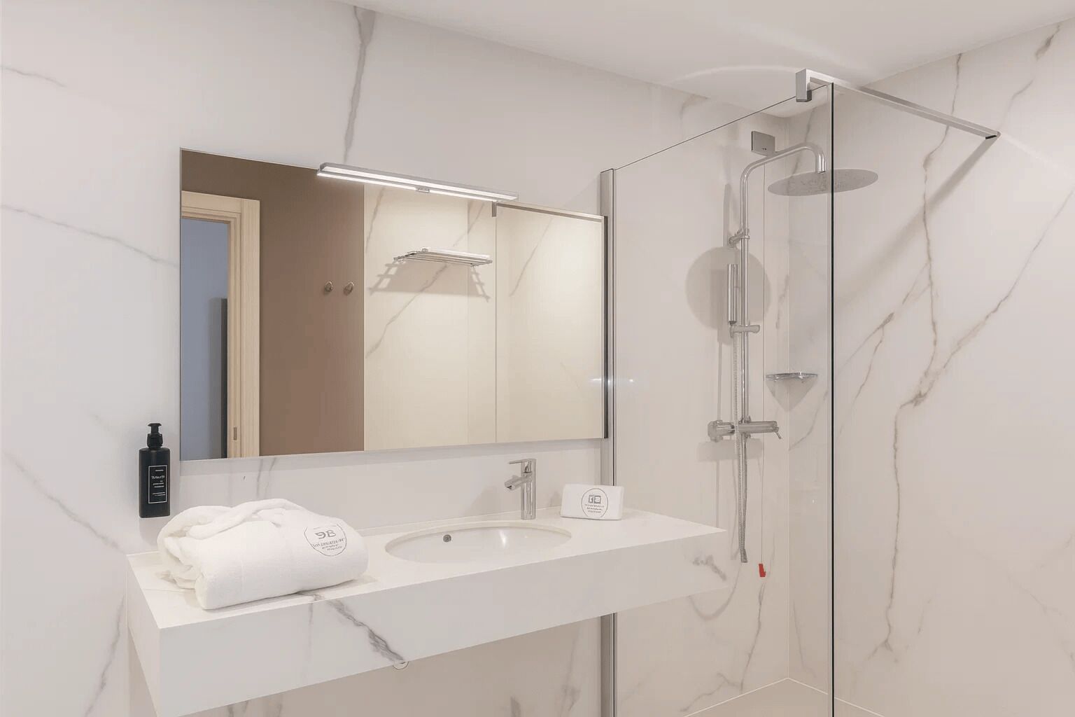 Shower, hair dryer, towels, toilet paper