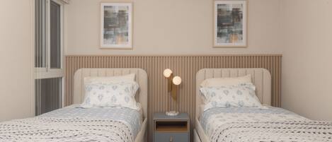 A bedroom with two beds, a bedside table with a lamp, and framed artwork on the wall.