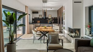 A modern living space with a dining area, kitchen, and seating area. - NEW! Villa Bella Ciao: A Stylish 3-Bedroom Retreat with Spectacular Split and Sea Views (Klis)