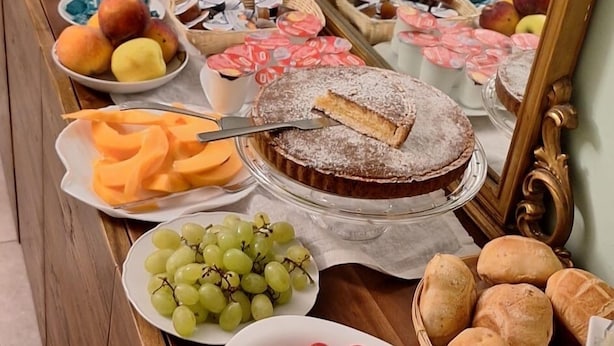 A buffet table with various food items including pastries, fruits, and desserts. - B&B Maison de Charme (Pompei)