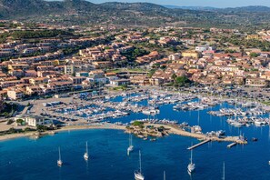 A coastal town with a marina filled with boats. - Elegant Studio in Sardinian Stone Residence (Palau)