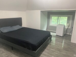 A bedroom with a bed, a window, and a heater. - 2 Bedroom Cozy Accomodation (Windsor)
