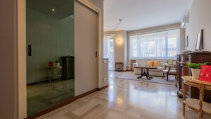 Amplia sala de estar con un conjunto de sofás, una mesa de centro y una mesa decorativa con una planta.