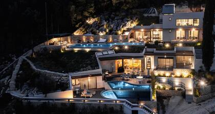 Luxury villa with infinity salt pool featuring a waterfall and gorgeous seaviews