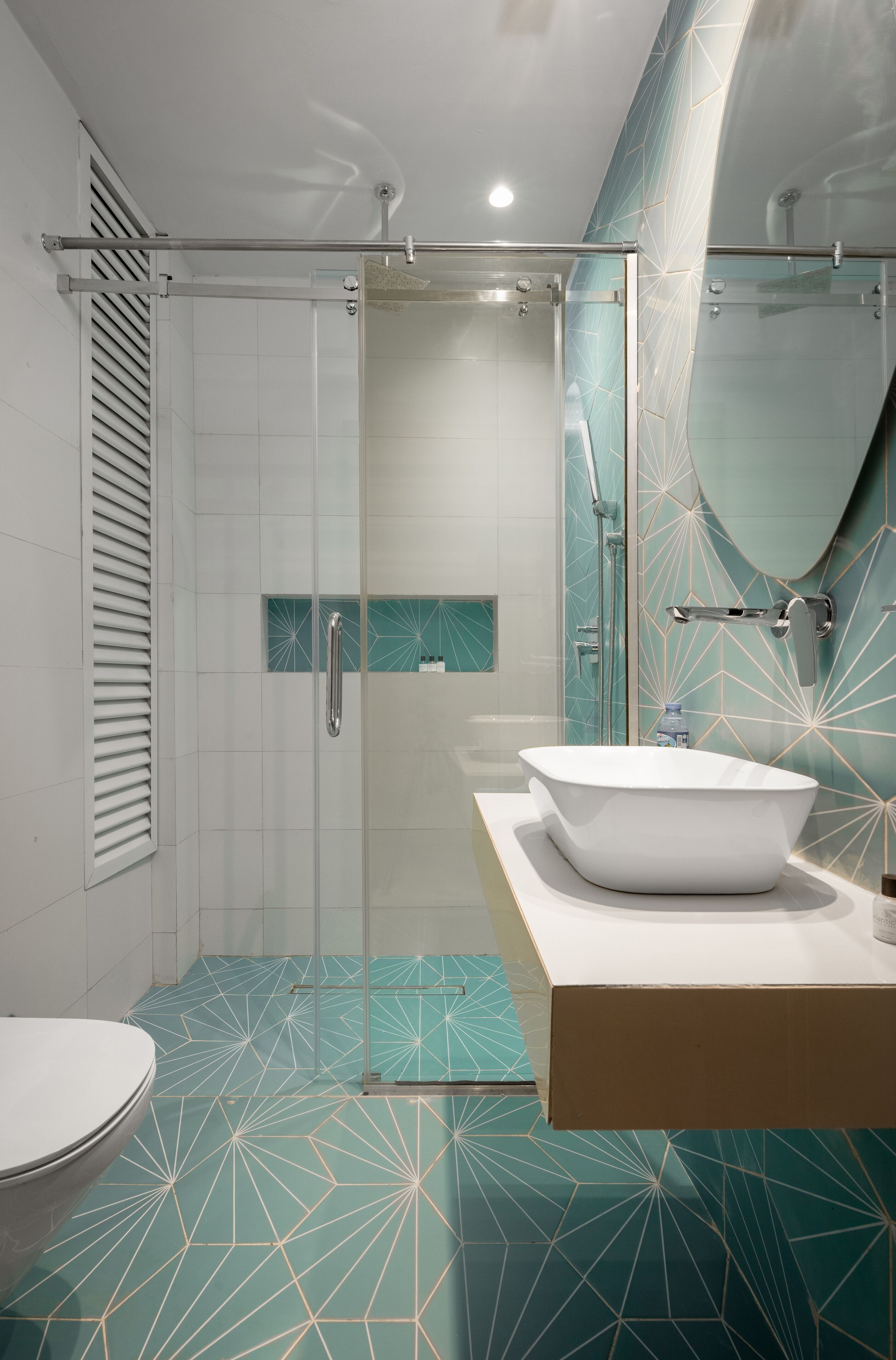 A modern bathroom with a glass-enclosed shower, a freestanding bathtub, and a large mirror.