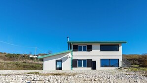 A modern two-story house with a flat roof, large windows, and a small attached garage. - Villa Donato (Filiano)
