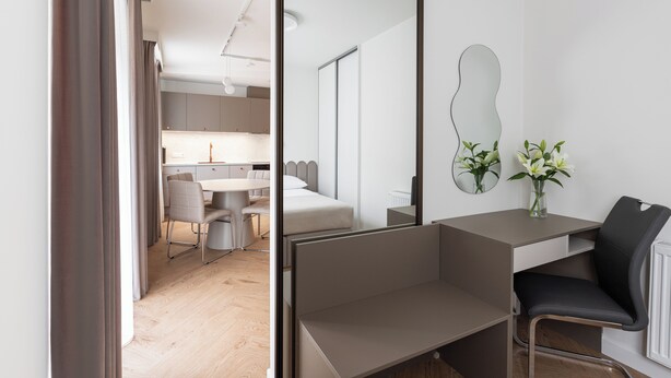 A modern hotel room with a desk, a chair, a bed, and a mirror. - Native Apartments Prądnicka 48 (Kraków)