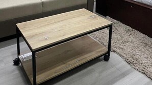A modern bedroom with a sofa, a bed, and a wooden coffee table. - Coromandel Suites (Chennai)
