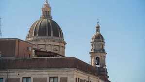 A historical building with a prominent dome and bell tower. - To complete (Catania)