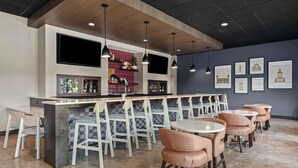 A bar area with a counter, multiple chairs, and tables. - Drury Plaza Hotel Tampa Brandon (Tampa)