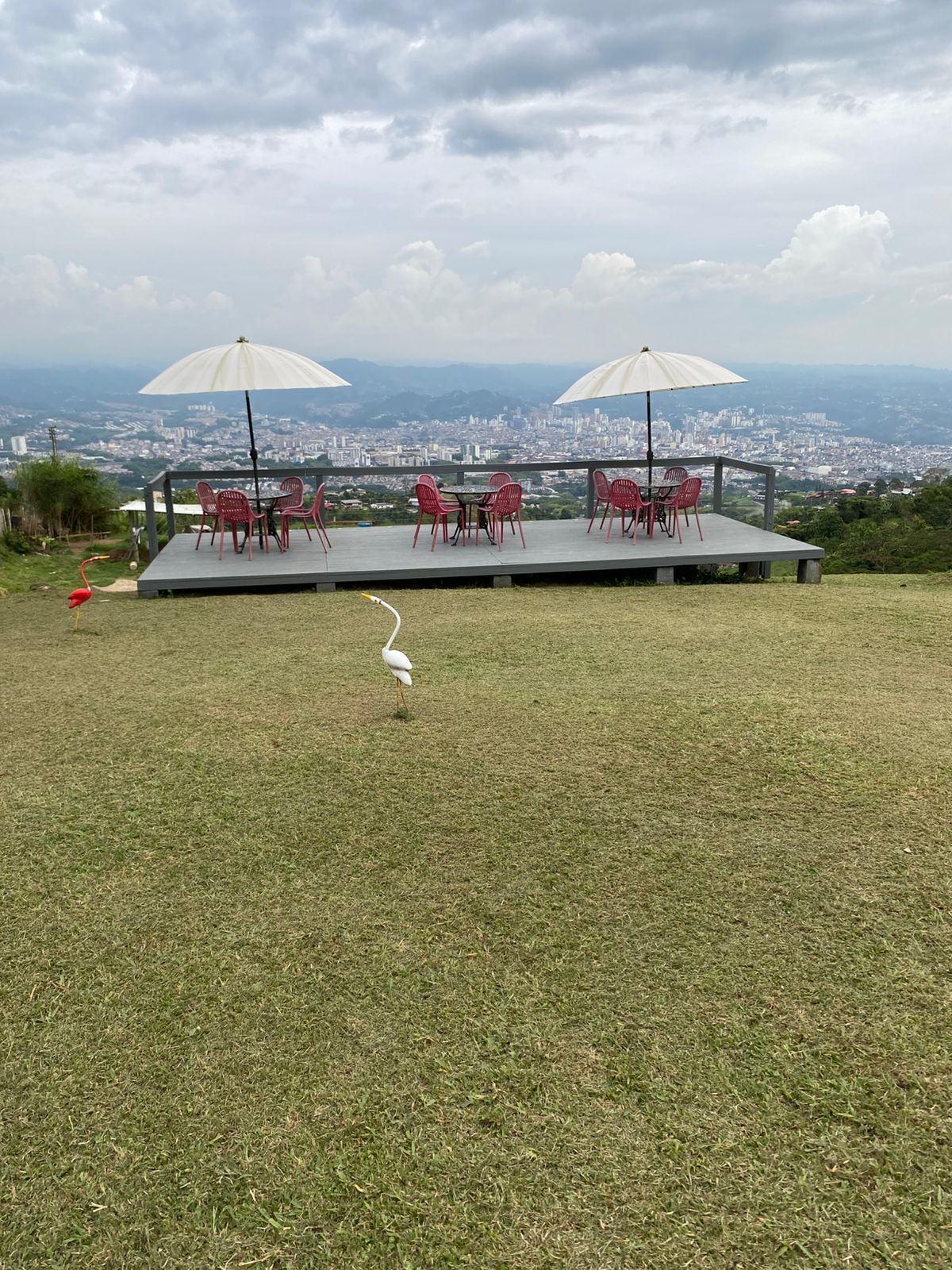 A terrace with outdoor seating and a view of a cityscape.
