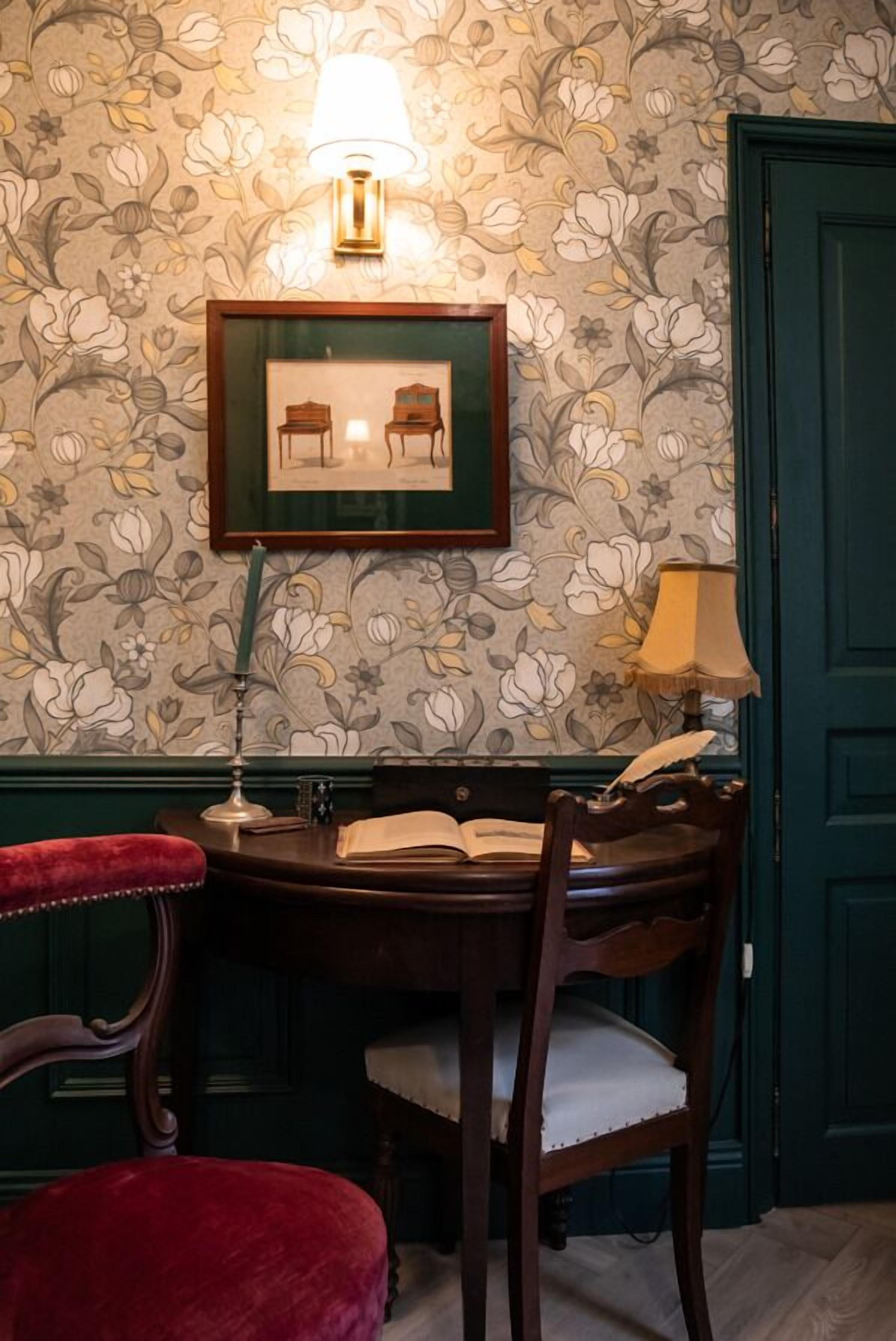 A dining area with a wooden table, chairs, and a framed picture above.