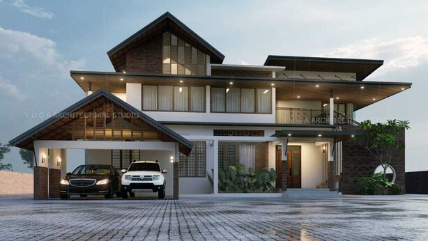 A modern two-story house with a garage, a balcony, and a well-lit entrance. - 5-bedroom upper house in Wayanad for a relaxing getaway (Kalpetta)