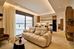 Family Villa, 2 Bedrooms, Private Pool, Sea View | Living area | 55-inch Smart TV with satellite channels - POLYTELIA | Luxury Living (Hersonissos)