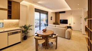 A modern living space with a kitchen, dining area, and a sofa in the living room. - POLYTELIA | Luxury Living (Hersonissos)