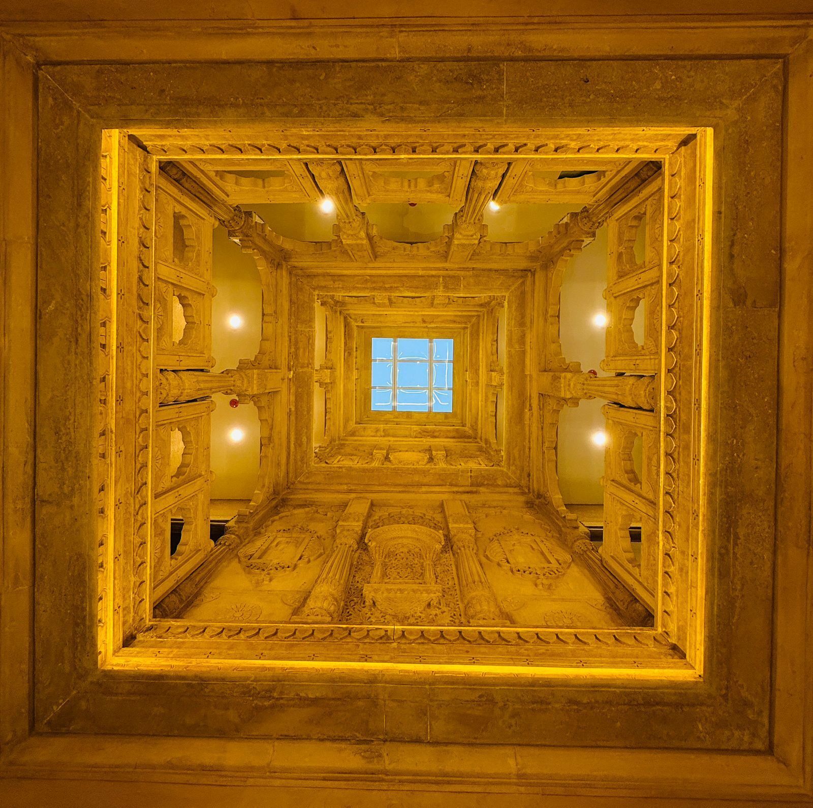 A corridor with ornate carvings and a central window.
