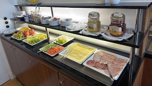 A buffet with various food items including fruits, cheeses, and meats. - Villa Weißer Berg (Neuwied)