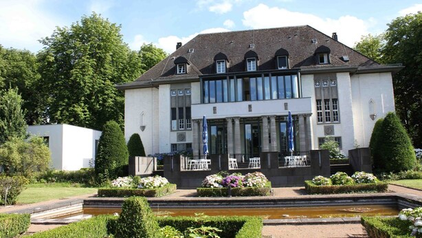A large, two-story building with a symmetrical facade, large windows, and a central entrance. - Villa Weißer Berg (Neuwied)