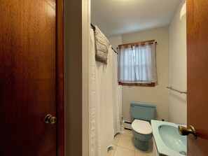 A bathroom with a toilet, bidet, and a sink.