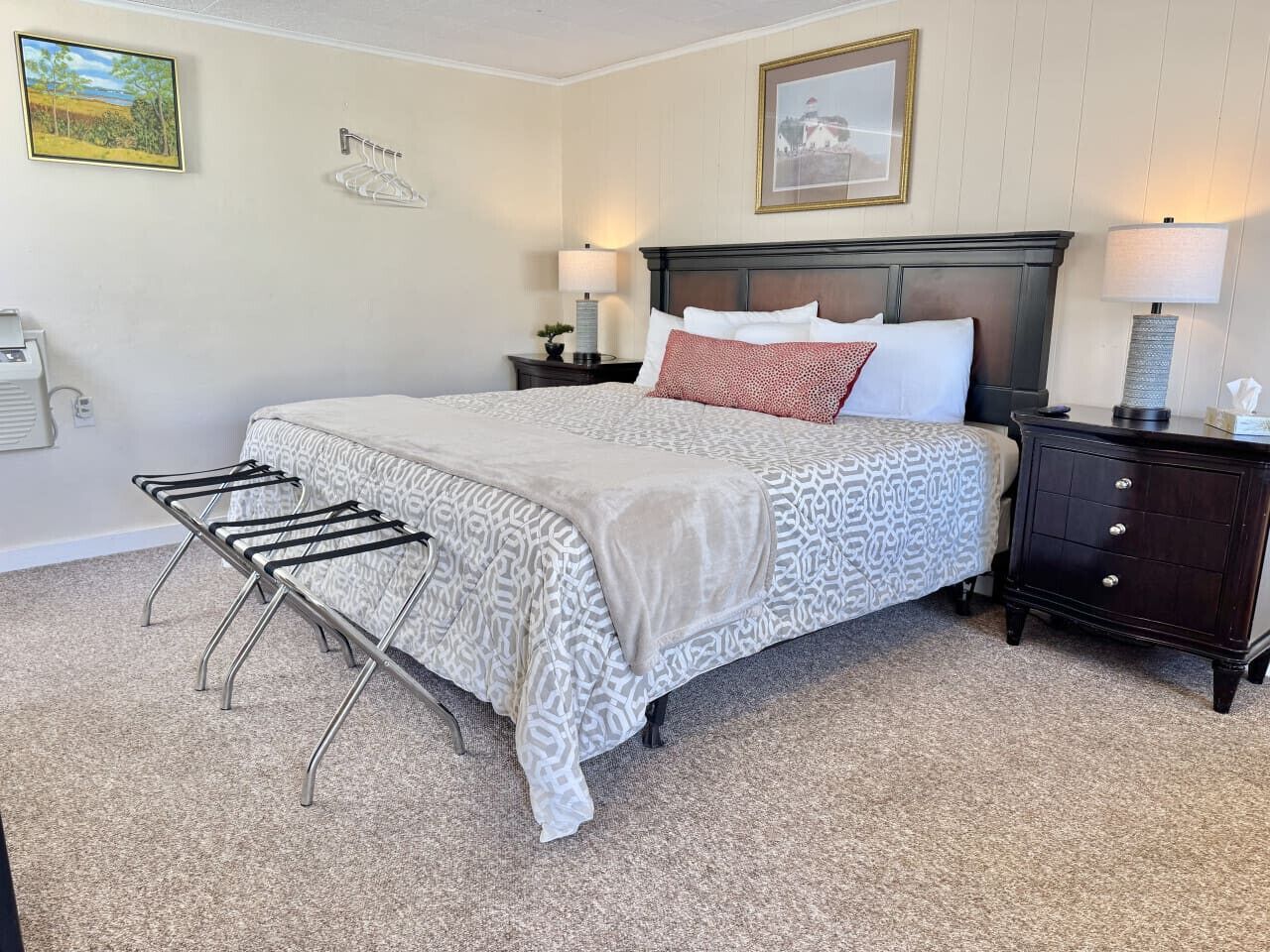 A neatly arranged bedroom with a bed, bedside tables, a lamp, and a radiator.