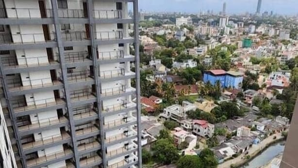 A high-rise building with a rooftop pool, surrounded by a dense urban landscape. - H2o Residences Colombo (Colombo)