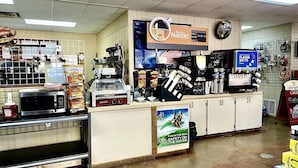 A fast-food restaurant with a counter, a microwave, and various food items like nachos and chips. - Water front cabin #12 Cabin in Graham, steps from Possum Kingdom Lake (Graham)