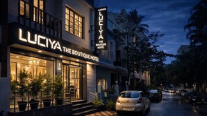 The Boutique Hotel Luciya with a visible entrance, potted plants, and a checkered pavement. - Luciya The Boutique Hotel (Bengaluru)