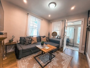 A living room with a sofa, coffee table, and a rug. - Premium Private Home w/ Parking, Yard, Pets Welcome! Near Newark Airport & NYC (Union)