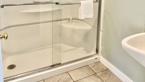 A glass-enclosed shower with a towel rack and a sink. - Gallagher`s Travels Room 7 (Double Queen) (Bar Harbor)