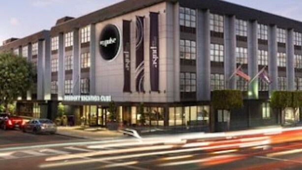 A modern hotel with a large sign, multiple floors, and a well-lit facade. - Enjoy all San Francisco has to offer for Super Bowl Weekend! (San Francisco)