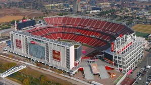 A large stadium with multiple tiers of seating and a prominent advertisement on the side. - Enjoy all San Francisco has to offer for Super Bowl Weekend! (San Francisco)