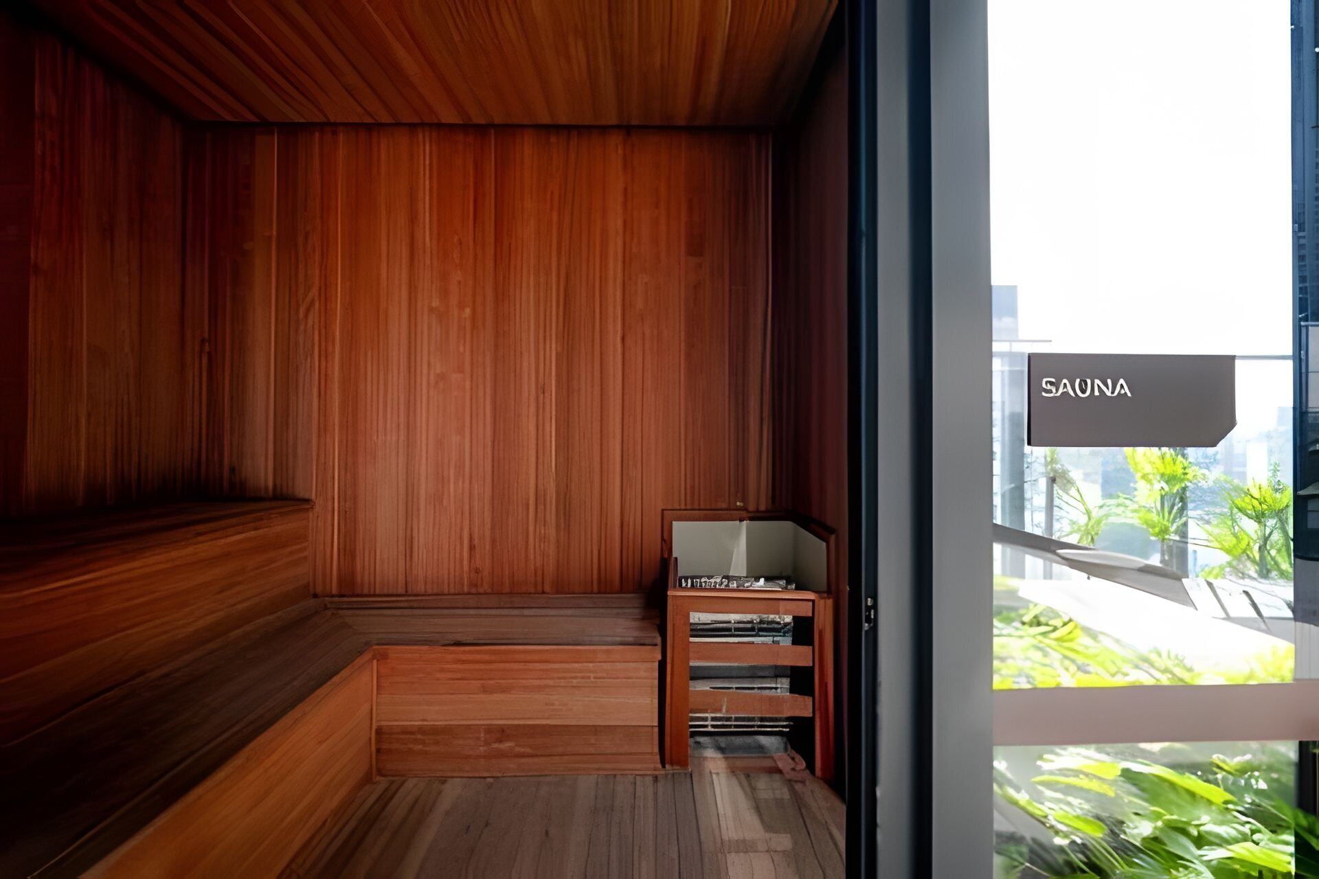 A sauna room with wooden walls and a bench.