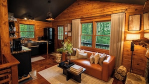 A log cabin interior with a kitchen, dining area, and living room. - Lover’s Stone • Cliffside Hot Tub + Sauna + Cinema + Fireplace + Firepit (Blue Ridge)