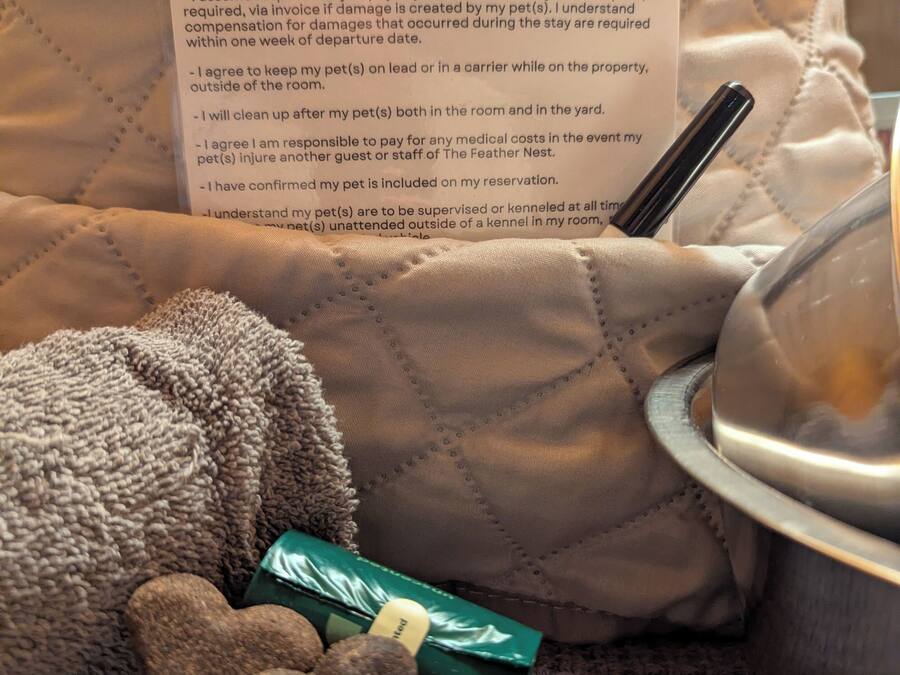 A pet bed with a feather nest pet agreement on it.