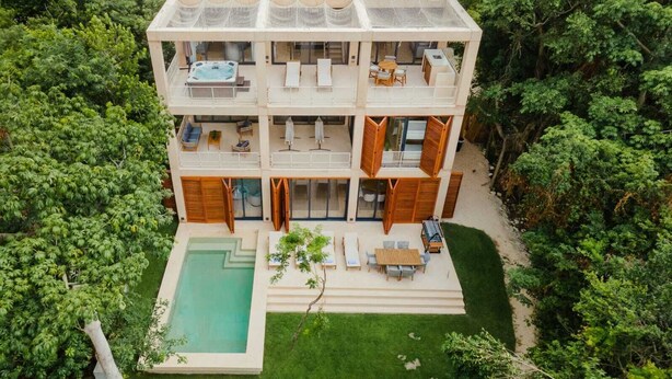 A multi-story house with a swimming pool, outdoor seating, and a hot tub. - Luxury 5Br Villa with Private Pool (Playa del Carmen)