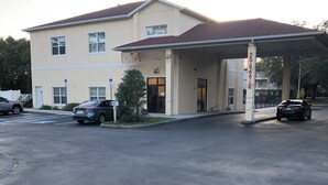 A building with a gas station and a parking lot.