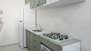 A kitchen with a gas stove, sink, and a built-in oven. - Apart w/ BBC 750 m From the Beach Sfr0411 (Barra Velha)
