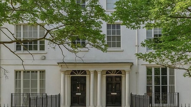 A building with a symmetrical facade, large windows, and a central entrance with columns. - Tavistock House-contractor Stay-parking-sleeps 7, (Bedford)