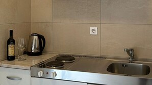 A kitchen with a built-in stove, a sink, and cabinets. - Apartments Adriana Studio apartment 4 (Podaca)
