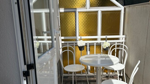 A small outdoor patio with a round table and four white chairs. - Apartments Adriana Studio apartment 4 (Podaca)