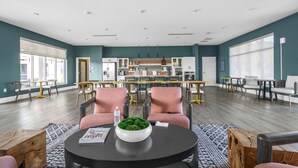 A spacious room with a kitchen area, multiple seating arrangements, and large windows providing natural light. - Beautiful 3BR Ocala Home | Perfect for Families (Ocala)