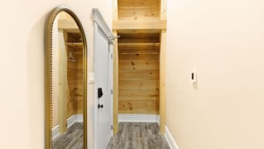 A narrow hallway with wooden paneling and a white door. - 124 Hurontario Unit 3 (Collingwood)
