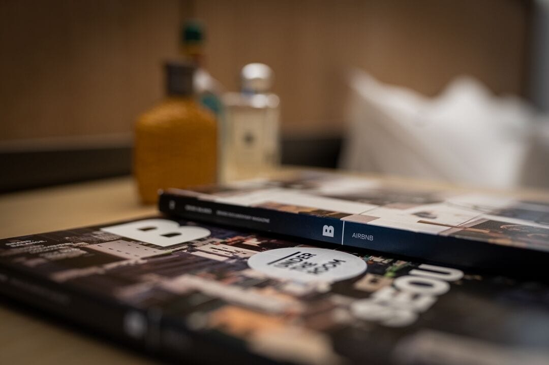 A magazine or book with a cover featuring various images and text, placed on a table.