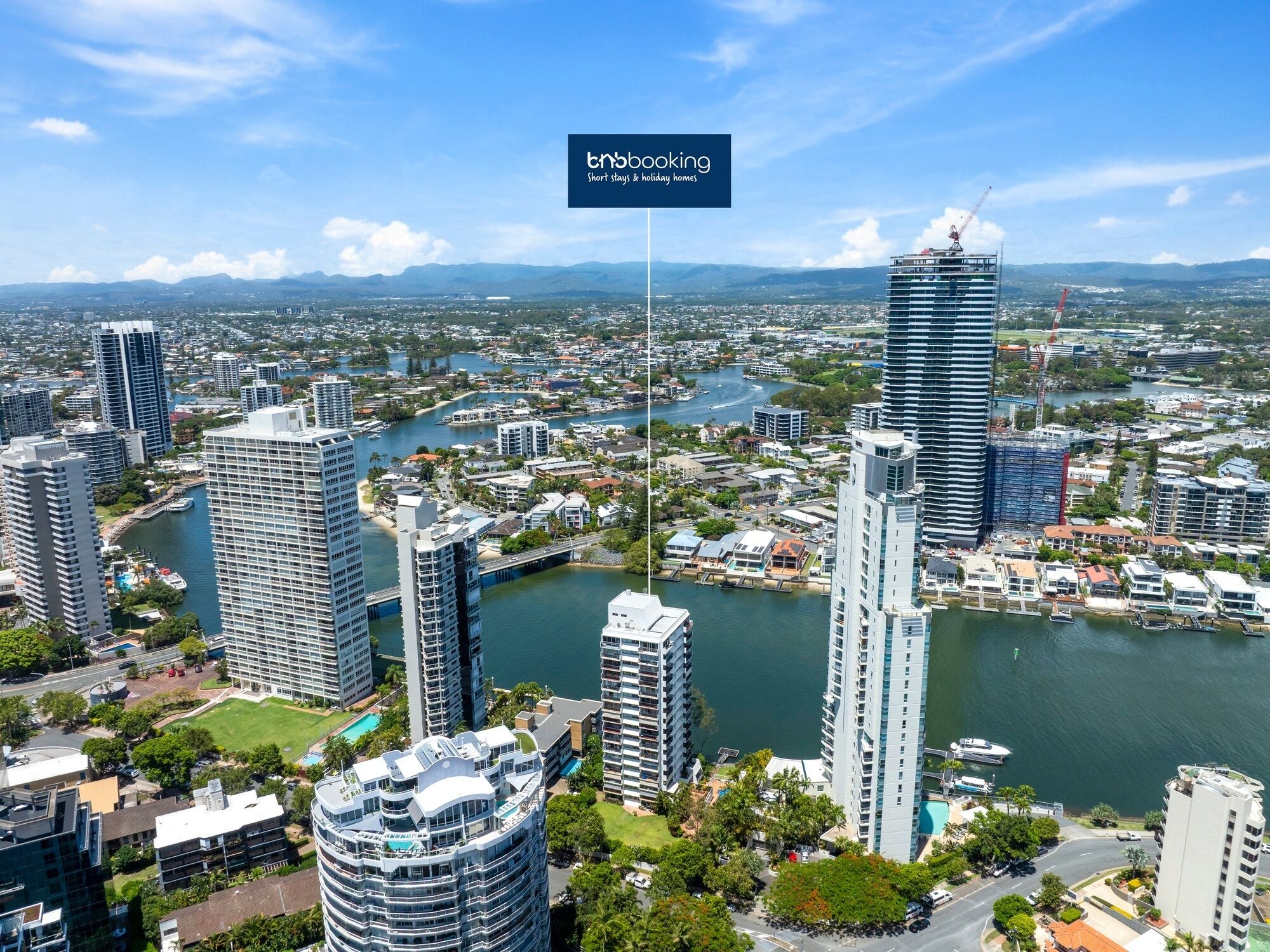 A high-rise hotel with a view of a river and surrounding cityscape.