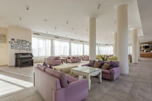 A spacious lobby with a piano, multiple sofas, and a reception desk. - Shoni Bay Resort (Marsa Alam)