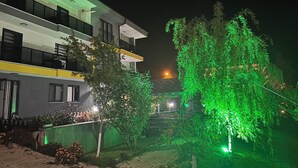 A modern building with multiple floors, large windows, and a well-lit exterior. - Golden Hour Apartment (Bursa)