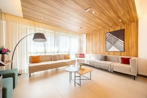 A modern living room with a sofa set, a coffee table, and a floor lamp. - Estúdio Premium Vila Olímpia -ap1901 (Sao Paulo)