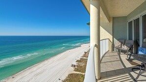 Uma varanda com vista para a praia e o oceano.
