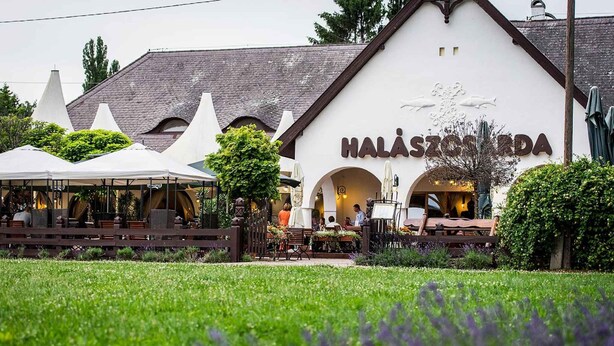 A restaurant named Halasztó Korda with outdoor seating and a garden view.