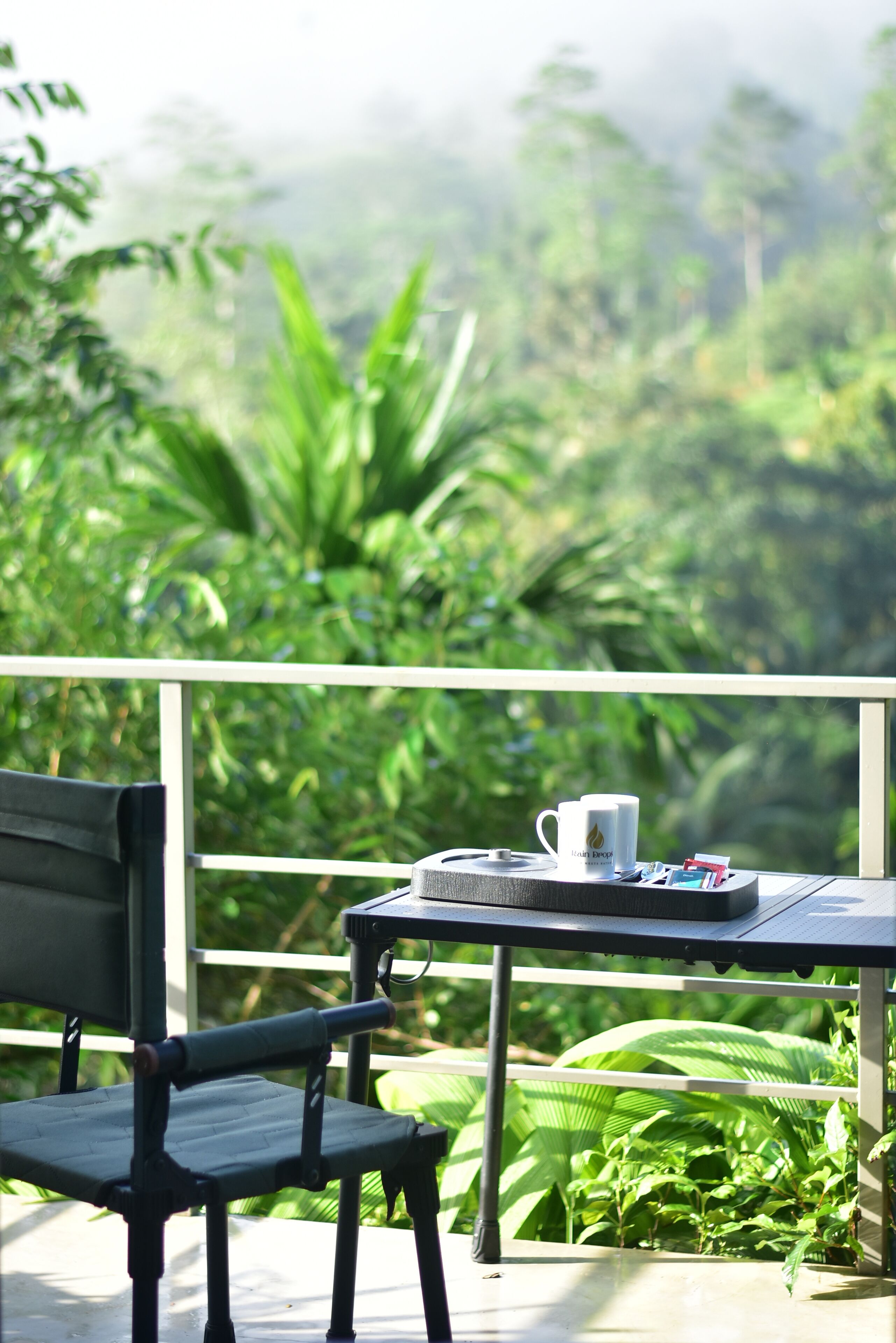 A balcony with a table, a chair, and a mug.